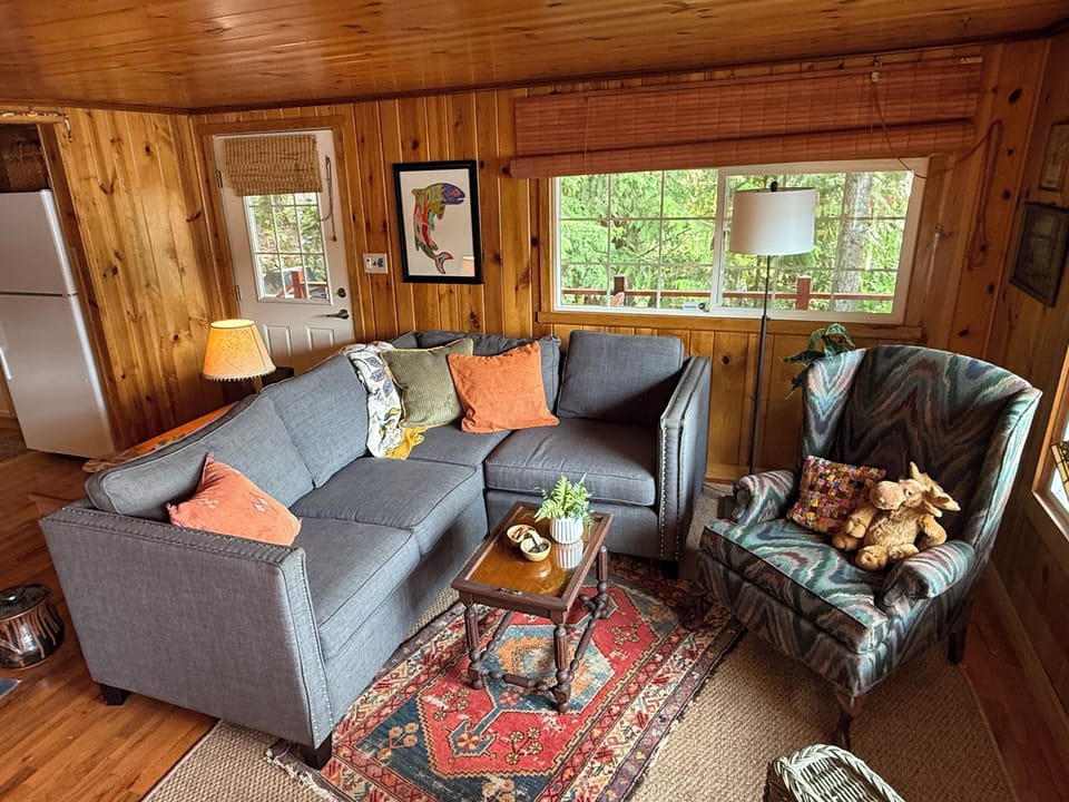 Cozy living room off the kitchen area with large picture windows to enjoy lake V