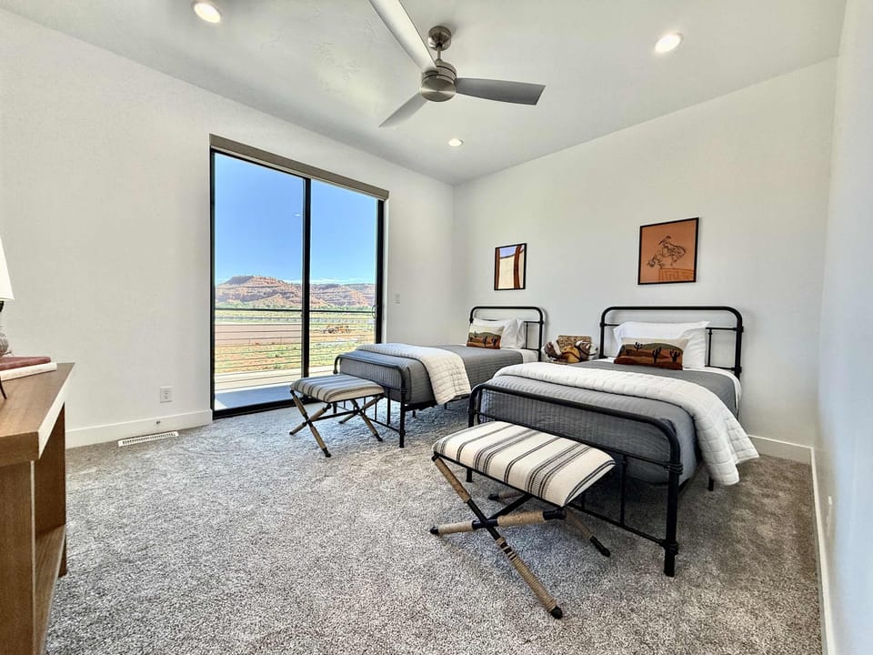 Bedroom 3 is furnished with 2 twin sized beds and balcony access