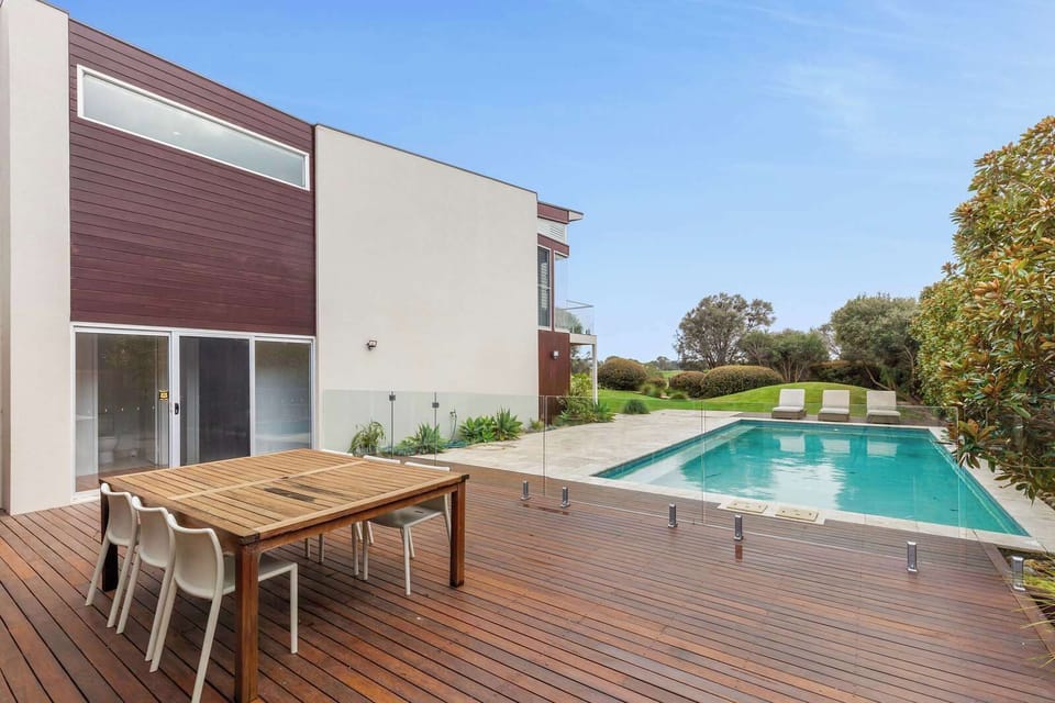 The sparkling pool is a guest favourite, offering a perfect way to relax. The outdoor space is surrounded by a deck with comfortable sun loungers, and an outdoor dining table