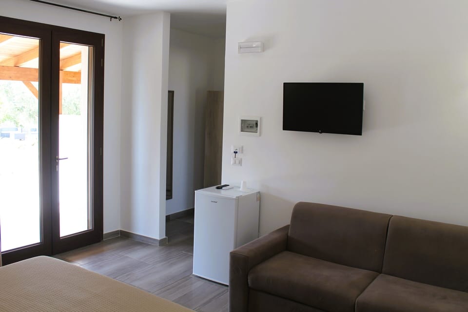 Comfort Quadruple Room, Patio, Garden View | In-room safe, blackout drapes, free WiFi