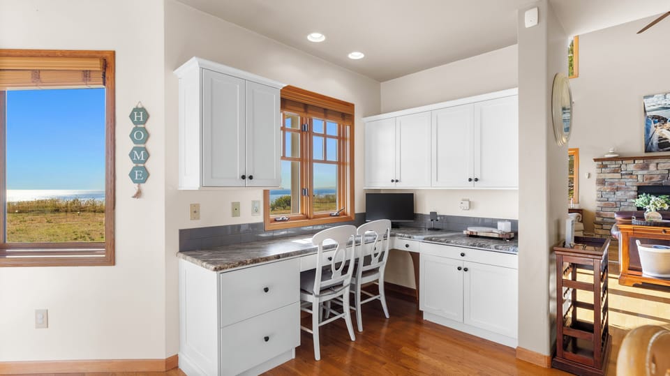 Spacious kitchen counter with seating and a monitor, perfect for multitasking or staying connected while you cook.