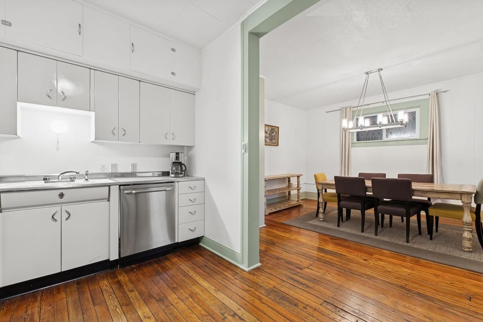 Your bright kitchen flows seamlessly into the elegant dining room, where warm hardwood floors create a welcoming space for memorable meals together.
