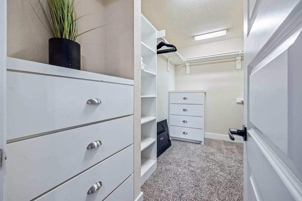 Fully-equipped primary bedroom closet.