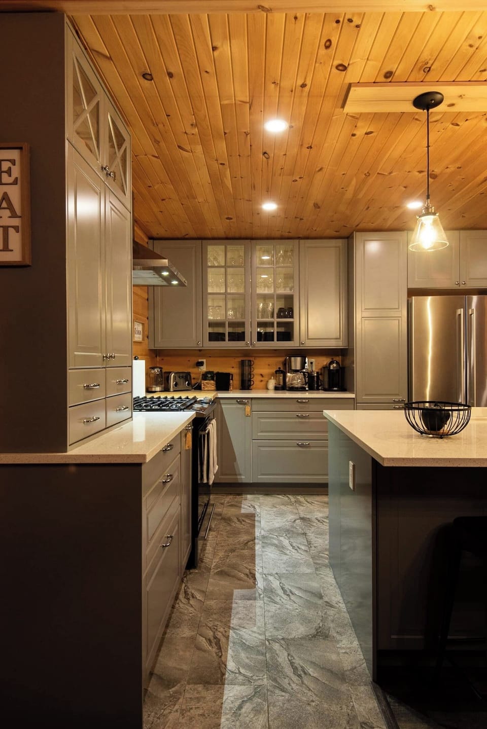 The modern kitchen glows with warmth in the evening—ideal for late-night snacks or a glass of wine.