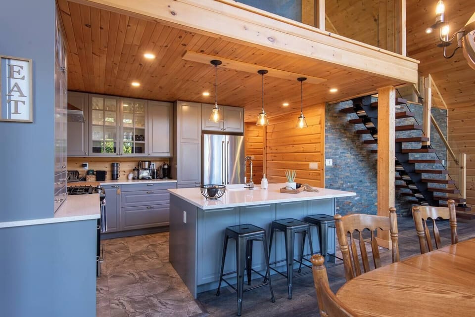 Gather around the stylish island with seating for three—perfect for morning coffee or evening wine.