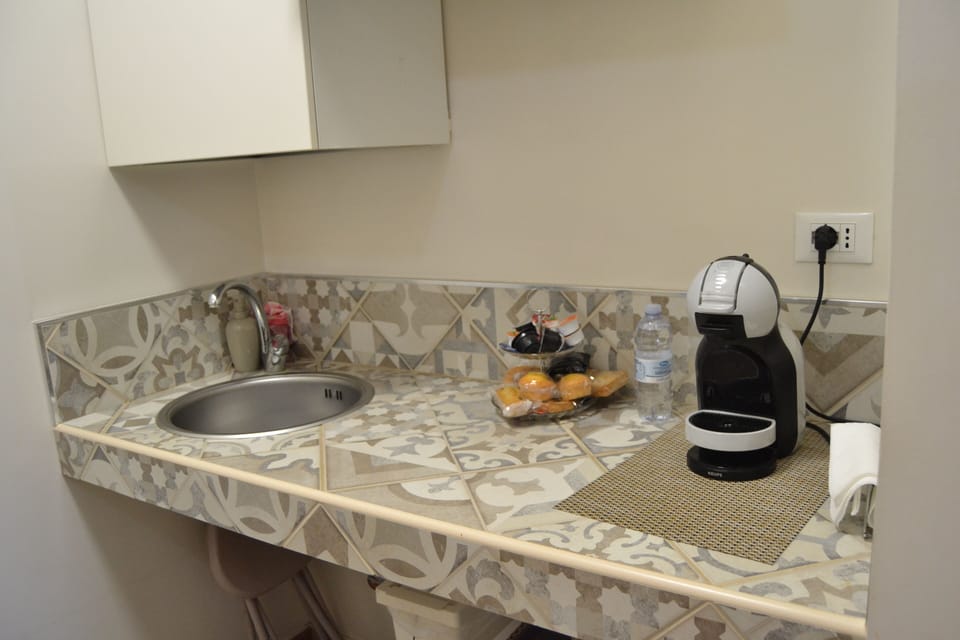 Deluxe Triple Room, Patio | Private kitchen | Fridge