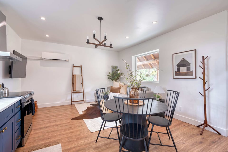 Round dining table set beside the kitchen for shared meals.