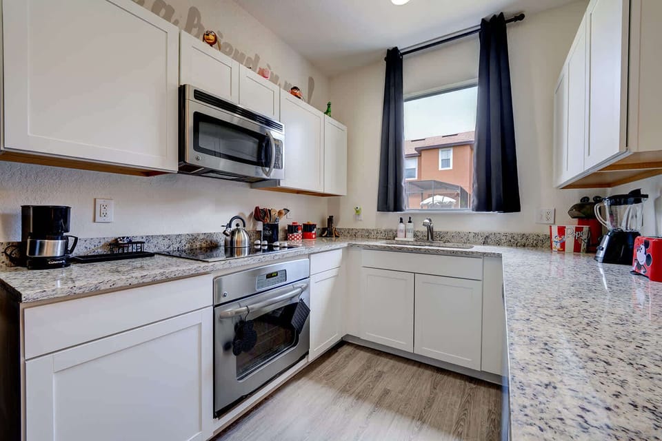 Modern kitchen with granite countertops and stainless steel appliances.