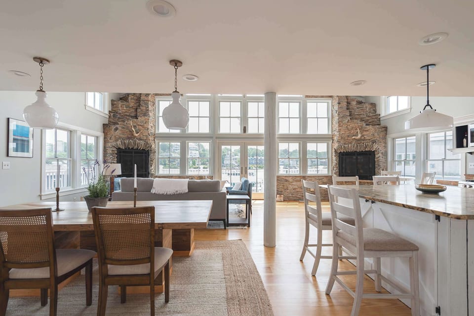 Open-concept kitchen and dining flow with water views