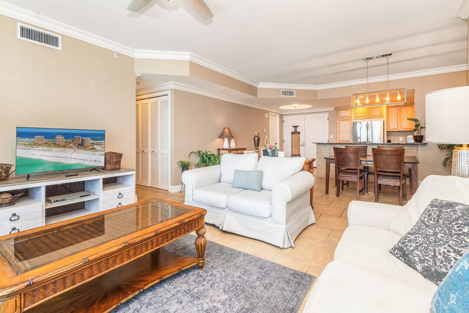 Unwind in this bright, breezy living space where soft coastal colors meet your home-away-from-home comfort. Relax on plush seating, gather around the dining table, and let the beachy vibe melt your stress away.