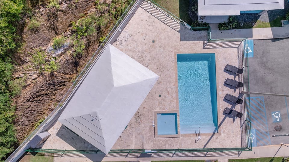 Pool Area: Dive into relaxation at this stunning pool with shaded gazebo and lounge chairs!