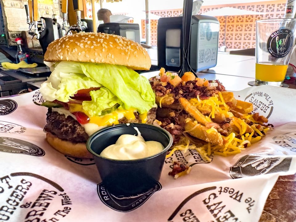 Local Gourmet Delight: Indulge in a burger feast topped with fresh ingredients and savory fries at Rock n Go. 