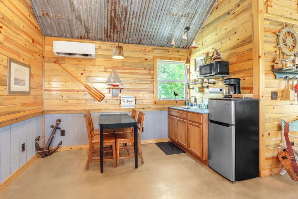 The cabin has a dining area and small kitchenette with microwave and mini fridge.