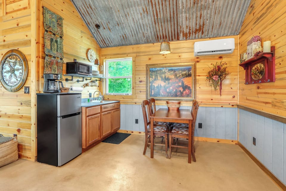 To the right of the living room is a kitchenette and dining area.