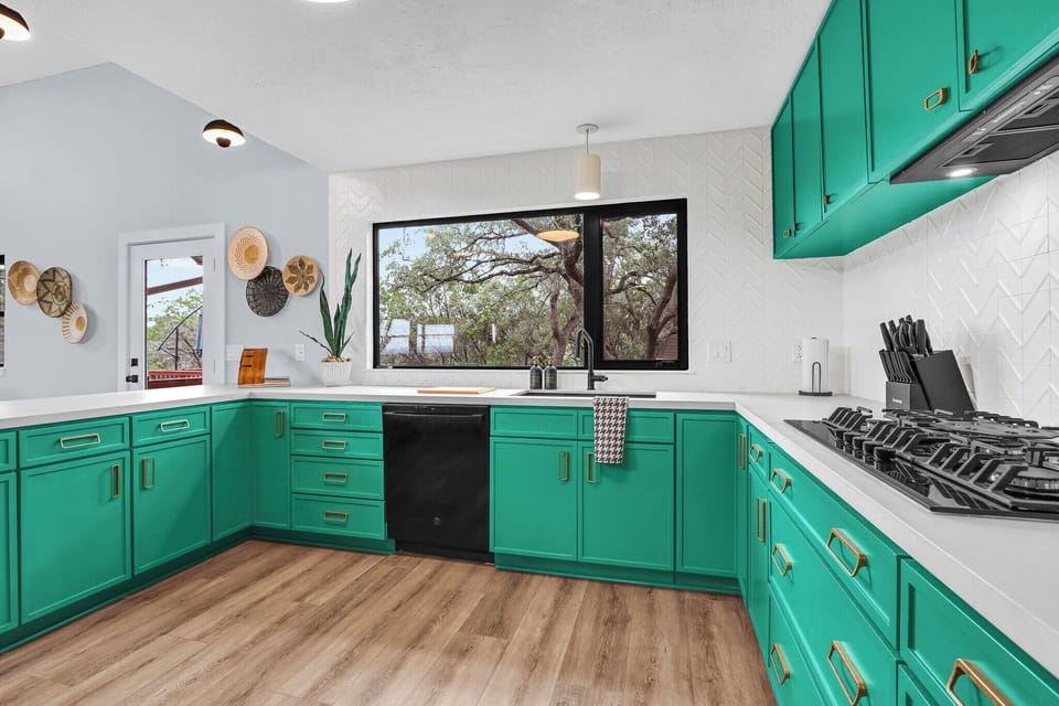 The kitchen features a range, sink, dishwasher, and lots of counter space.