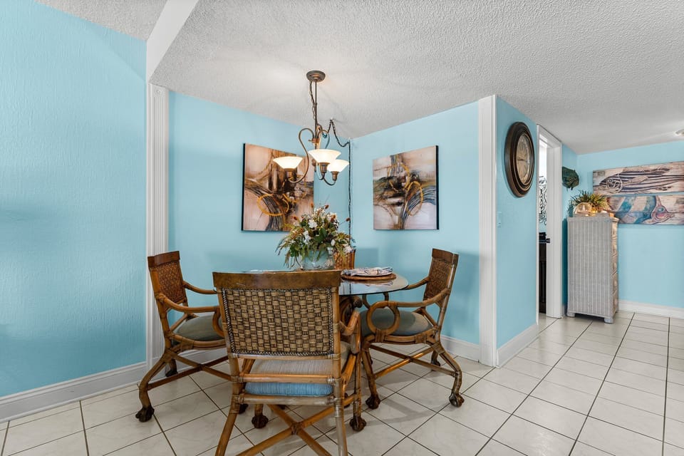 Cozy dining area w/ a chandelier — perfect for meals together.