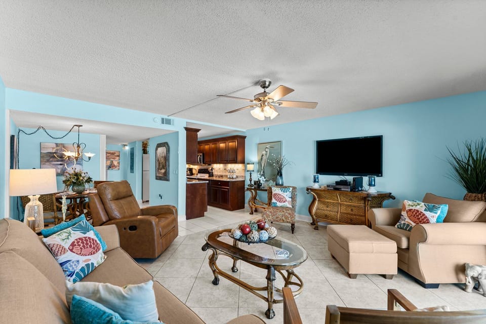 Spacious living area w/ ceiling fan, large TV, & plenty of room for the whole group to relax.