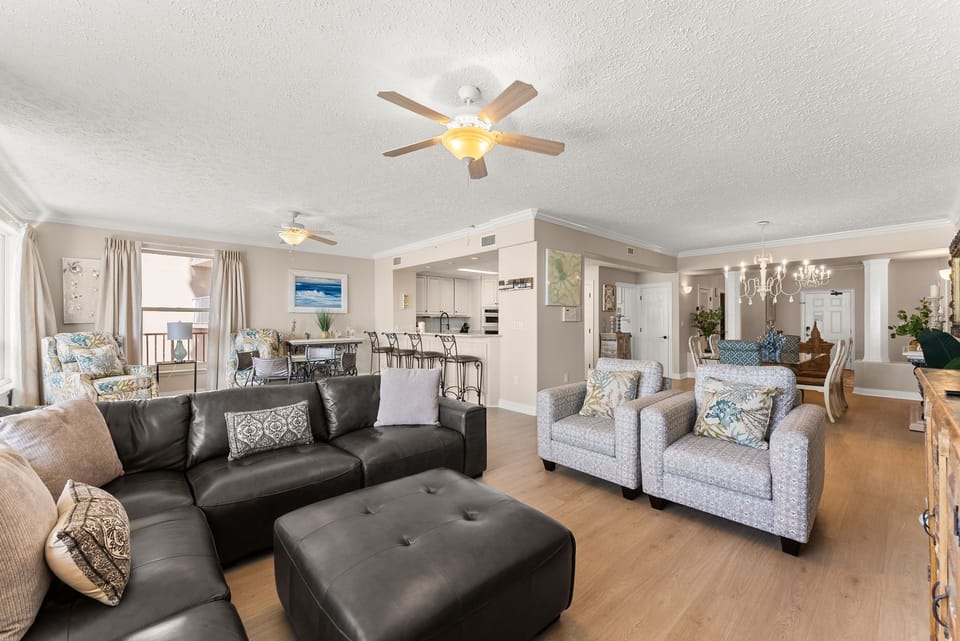 Spacious open-concept living area with modern seating and natural light.