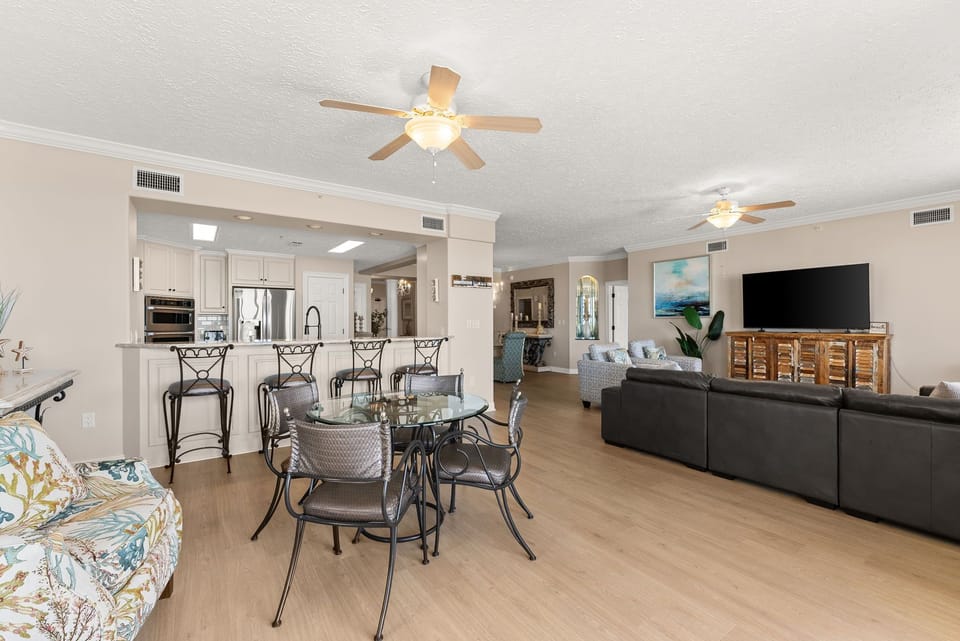 Open-concept living and dining area with modern kitchen and ample seating.