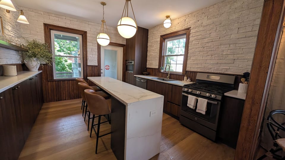 Gather your group around the marble waterfall island for morning coffee