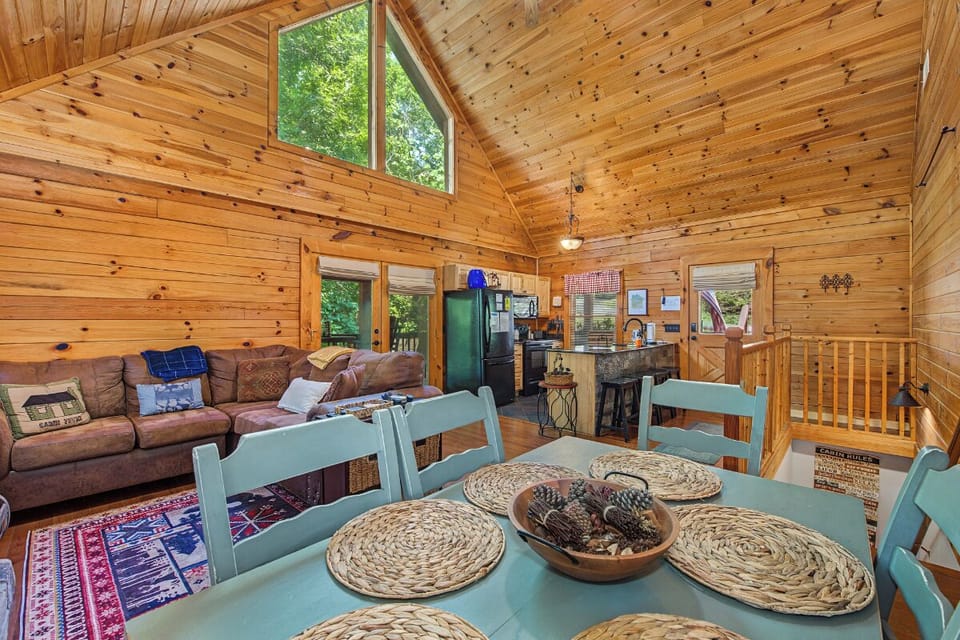 Picture yourself here: soaring cathedral ceilings, sun-dappled windows, and rich knotty pine warmth invite you to relax. Your perfect home away from home, where cozy living and rustic charm meet effortlessly.