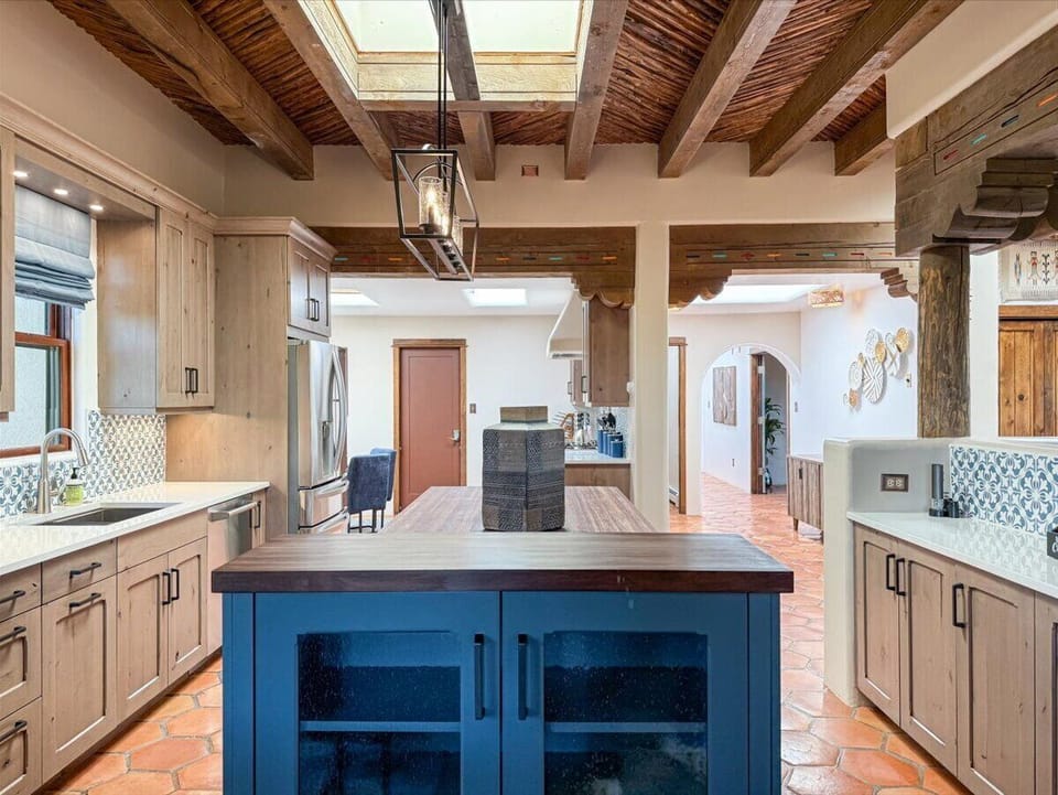 Expansive Gourmet Kitchen with Rustic beams and Modern Appliances