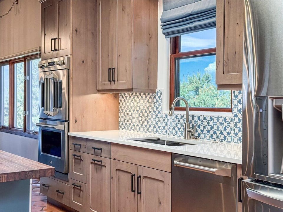 Charming Kitchen with Custom Wood Cabinetry and Scenic Window Views
