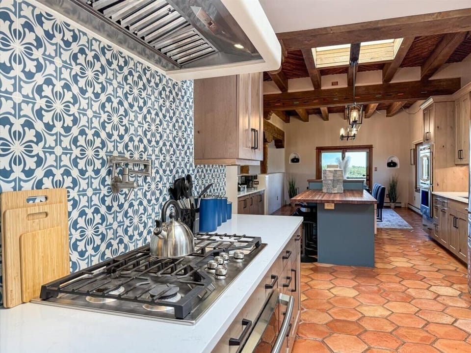 Bright Chef’s Kitchen with Artisan Tile and Skylit Island