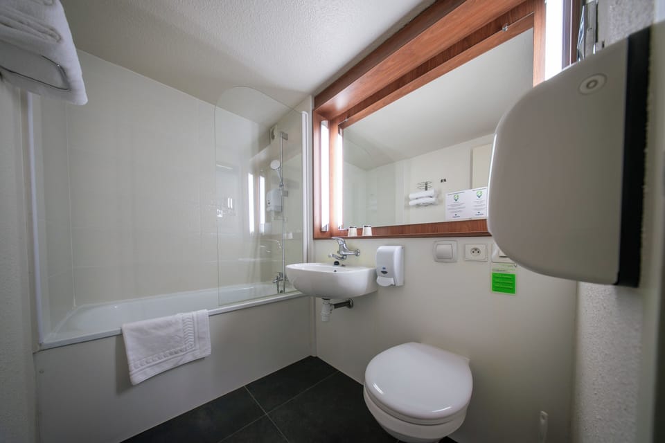 Bathtub, eco-friendly toiletries, hair dryer, towels