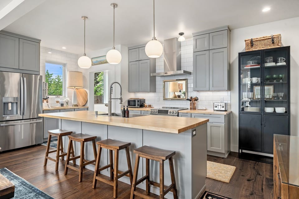 Light-filled kitchen with stainless appliances and ample counter space for prepping group meals.