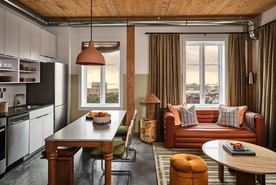 Living and kitchen area with wood table and Sofa.