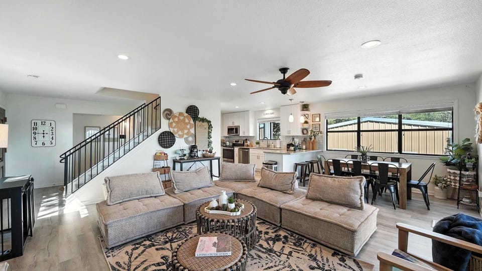 The living room’s massive sectional keeps everyone comfy, with an open floor plan perfect for gathering and fun.