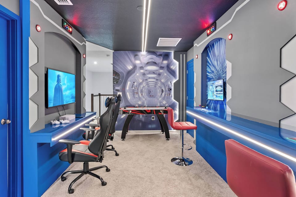 Discover a lively game room with sleek blue accents that enhance the playful vibe. Enjoy high-tech gaming stations and a stylish foosball table, perfect for friendly competition and relaxation in an energizing atmosphere.