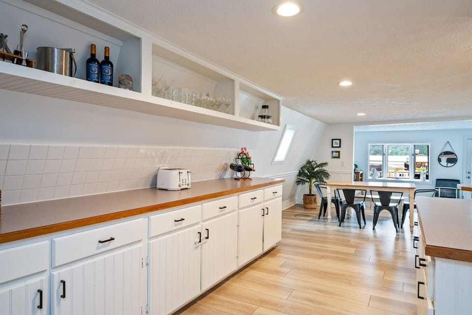 A bright and spacious kitchen with modern appliances, clean lines, and open shelving—perfect for preparing meals or enjoying your morning coffee. 🌟🍽️☕