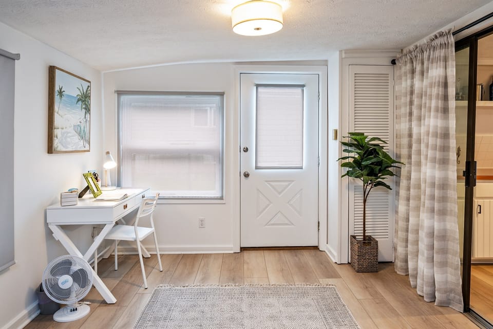A clean, inviting study area with a plant, fan, and soft lighting. A perfect spot to unwind or get some work done! 🌱💻🌟