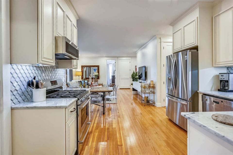 Unit 2 | Open Concept Chef's Kitchen | White Cabinetry | Island Seating | Second Floor
