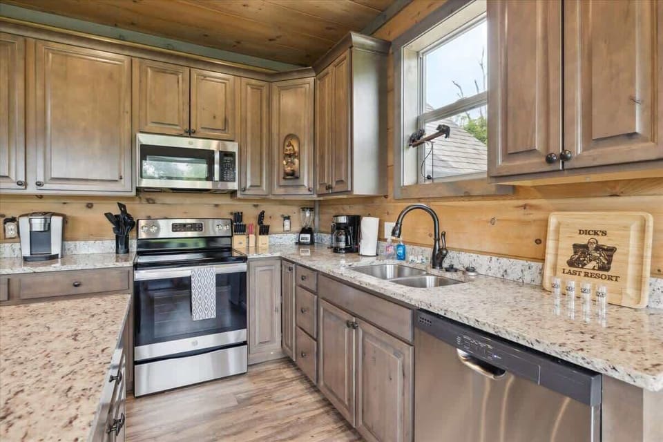 Kitchen: Chef's paradise with granite counters and wood accents, perfect for culinary adventures!