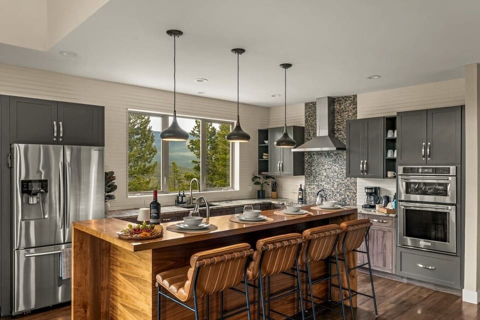 Beautifully remodeled chef`s kitchen with island and bar seating