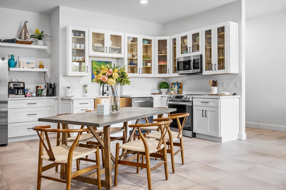 Modern kitchen with glass-front cabinets and a wooden dining table for family meals