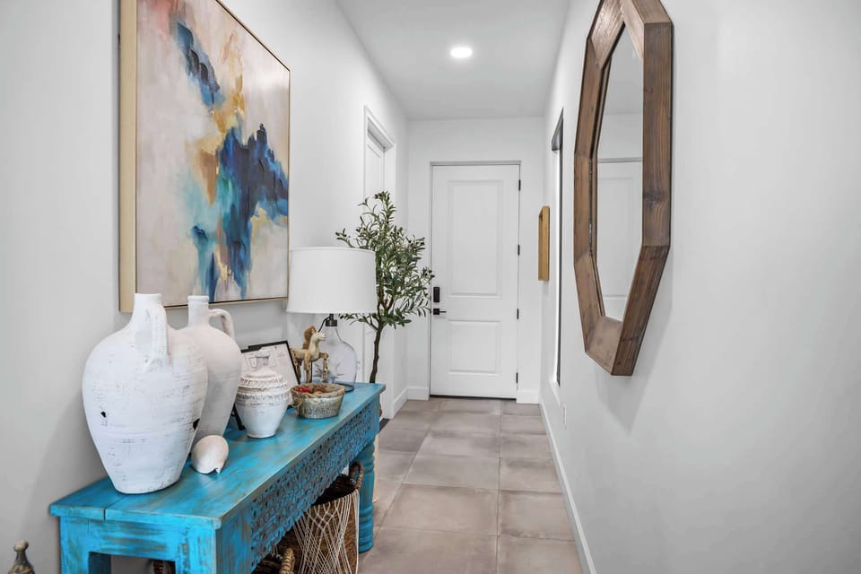 Entryway with a rustic blue console table and decorative accents