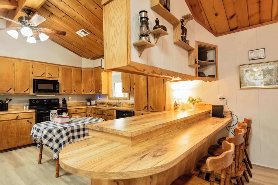 Kitchen equipped with a counter-height bar that offers seating for four, perfect for casual dining or entertaining.