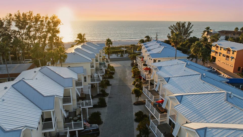 Wake up to ocean views and golden sunsets in this charming beachfront community. Just steps from the sand, enjoy breezy balconies, palm-lined paths, and coastal serenity perfect for relaxing, strolling, or watching the sunset over the waves.