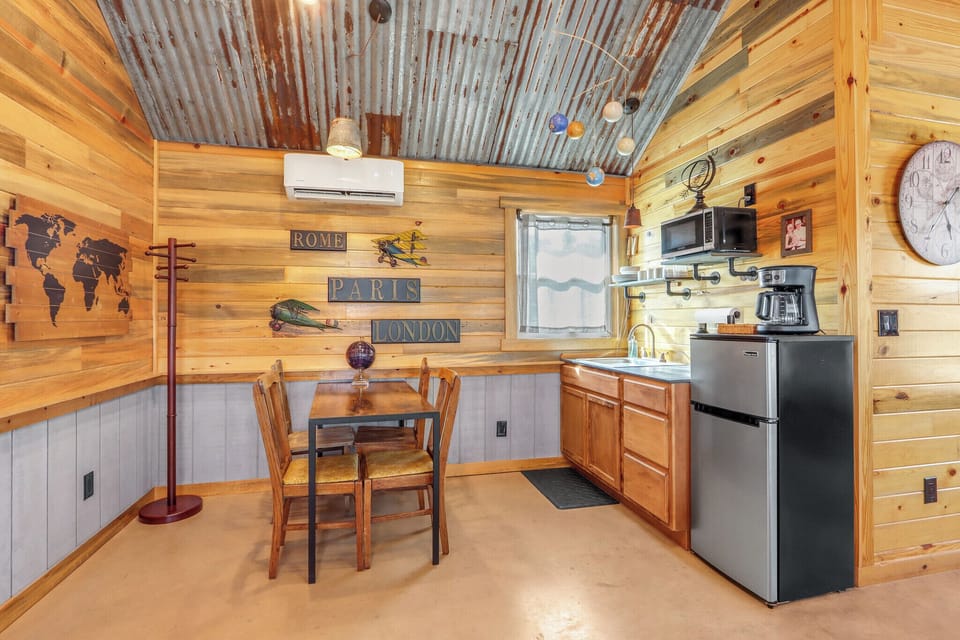The kitchenette is equipped with a refrigerator, microwave, and coffee pot.