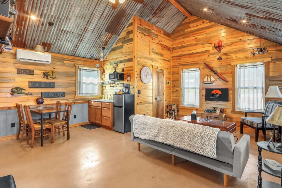 Open floor plan with living room, kitchenette, and dining room. An air mattress is available upon request for this area to sleep an additional 5th person.