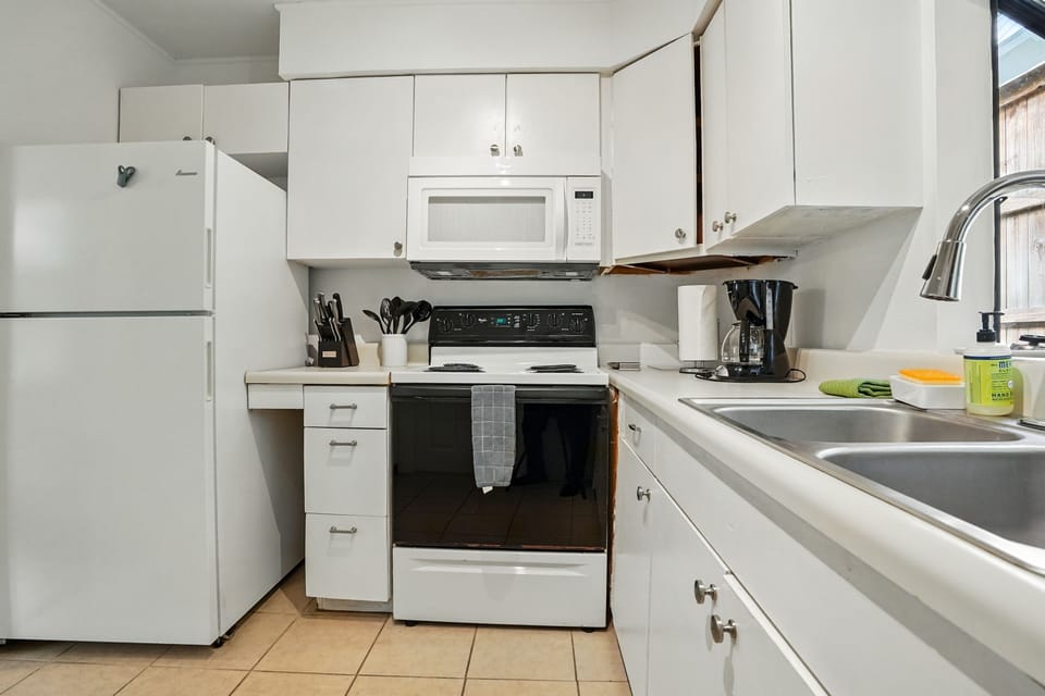 Kitchen Prep Space and Coffee Maker - Counter space, microwave, toaster, fridge, and coffee maker keep basics within reach.