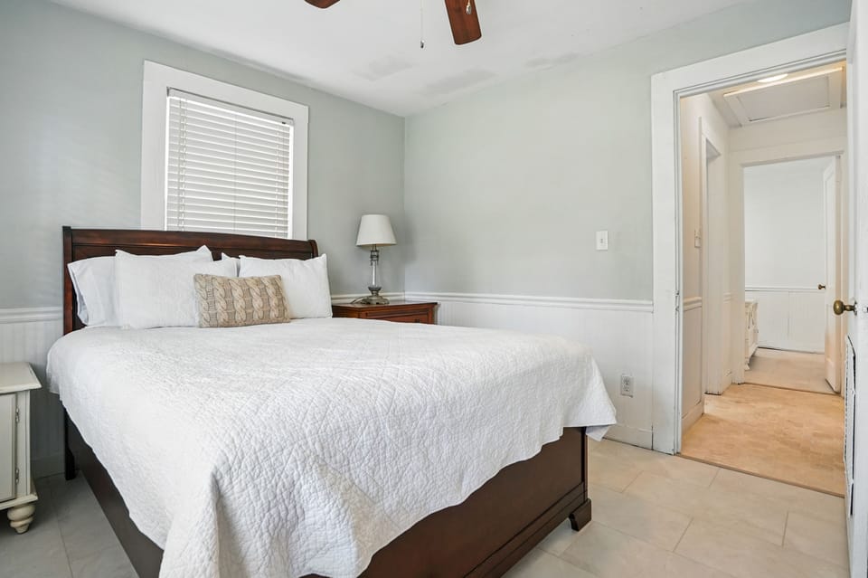 Front Queen Bedroom and Hall Bath Access - This angle shows the queen bed position beside the hallway and shared bathroom.