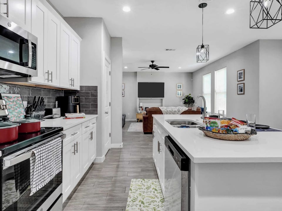 Kitchen: Bright and modern space, perfect for culinary adventures with a view of the living area!