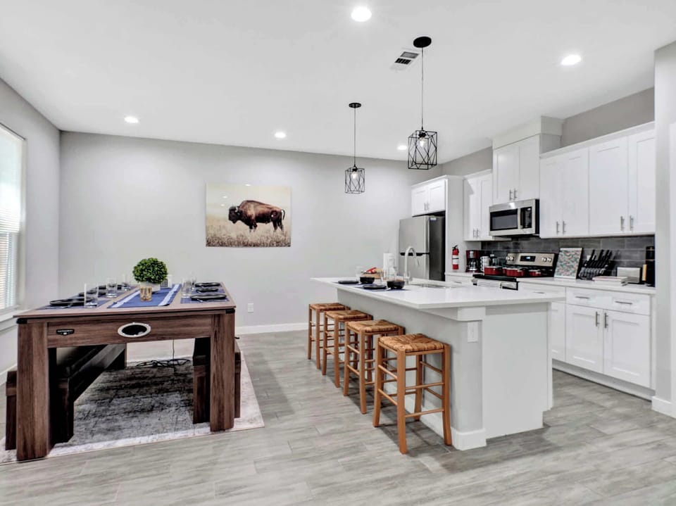 Kitchen: Modern design with vibrant decor, perfect for culinary adventures and gatherings! With Seating for 10 you're sure to entertain friends and family.