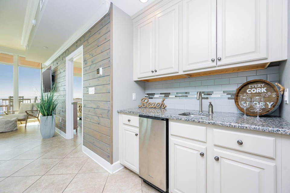 Enjoy mixing drinks at the convenient wet bar, creating the perfect refreshment to savor while relaxing by the coast