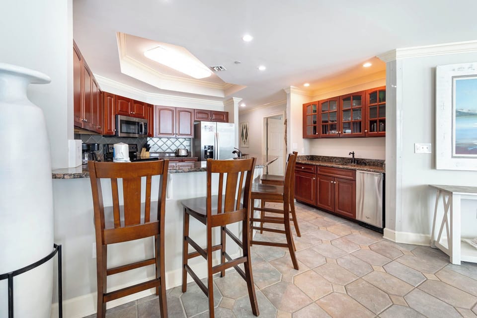 Gather around the inviting bar stools, enjoying drinks while sharing laughter and stories from your beach adventures